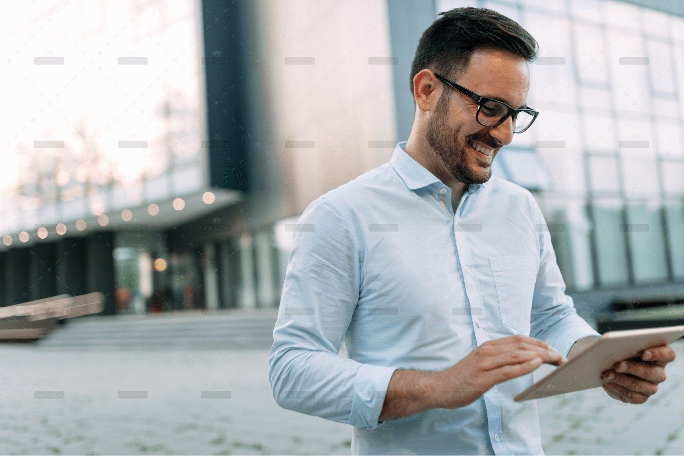 demo-attachment-467-portrait-of-businessman-in-glasses-holding-tablet-AWVHCJU